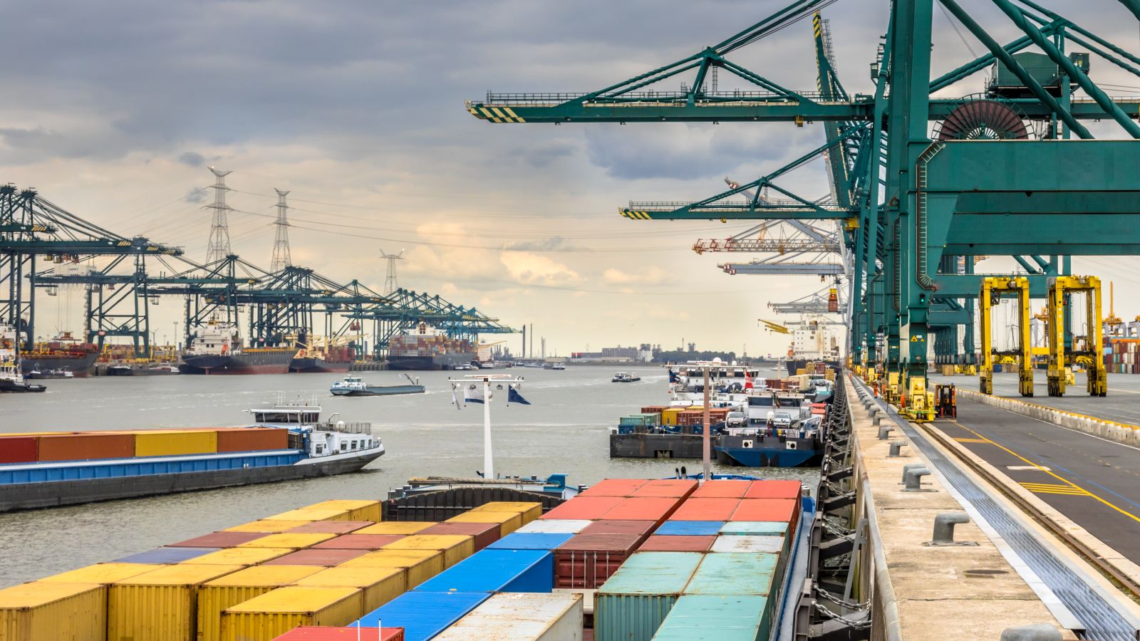 Ship-to-shore cranes working containers at a commercial port terminal