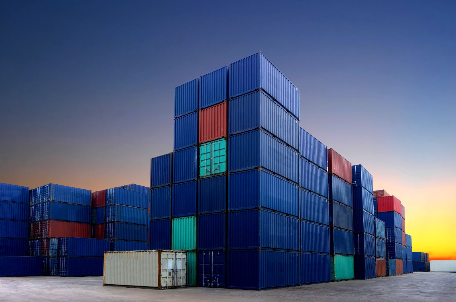 Stacked shipping containers in a port logistics yard